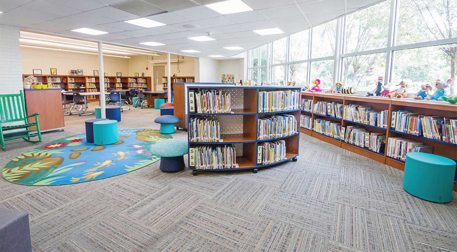 Elementary library shelving display with books and interactive resources
