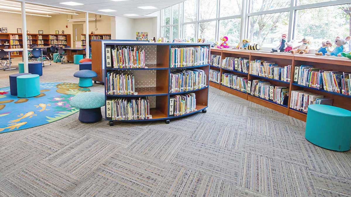 Curved library shelving in an elementary school for child-friendly book storage and display
