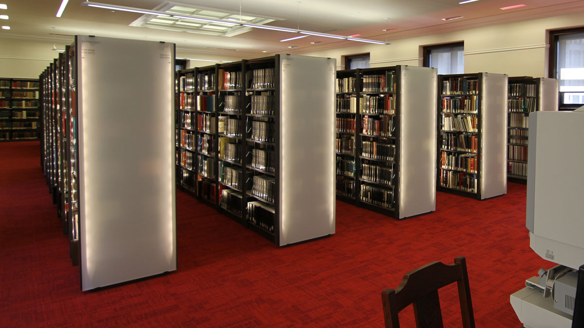 Library shelf lights providing focused illumination for reading and display areas