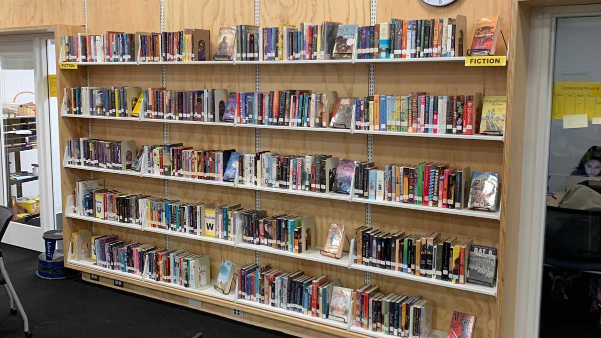 Wall-mounted cantilever library shelving in a public school library for efficient book storage