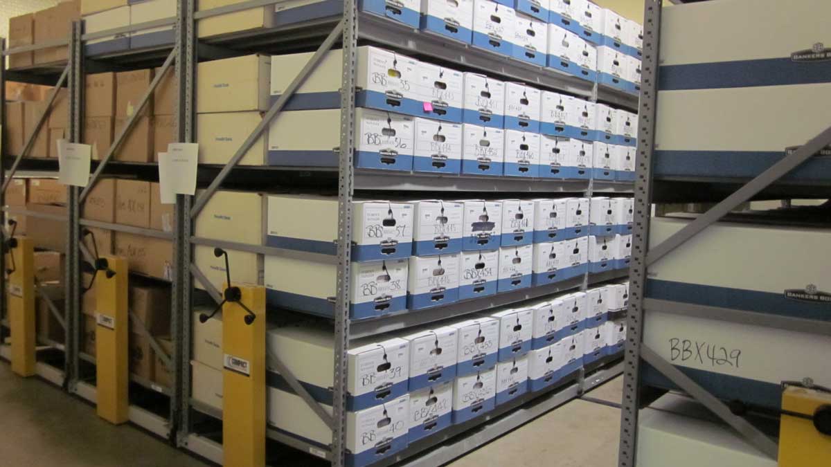 high-density mechanical assist shelving for storing record boxes in compact spaces