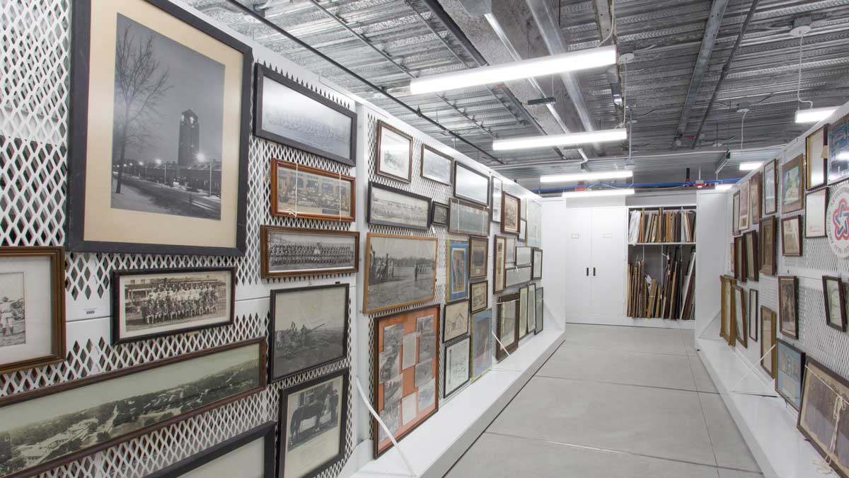 mesh panel wall system with hanging framed artwork in an organized storage setting