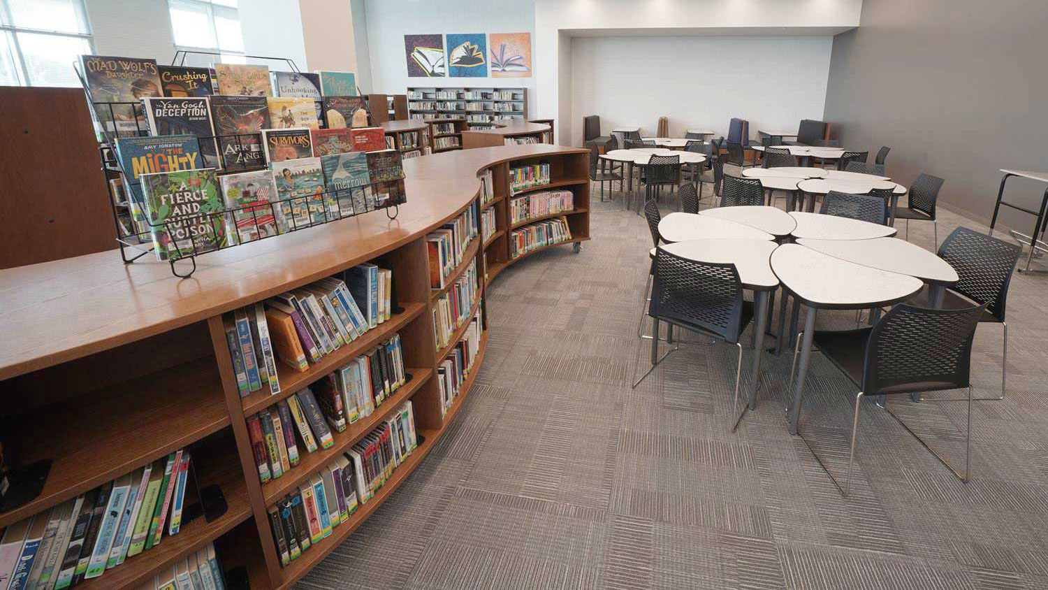 Curved library shelving system for modern library layouts and efficient storage