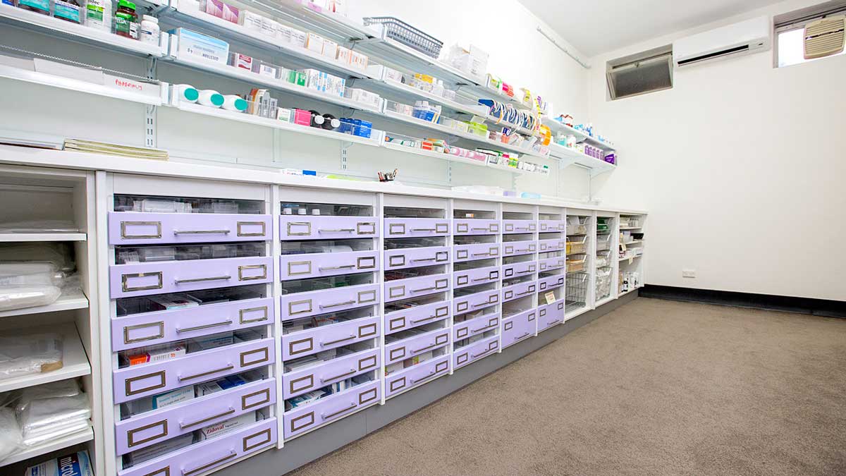 Pharmacy shelving with drawers organizing medications