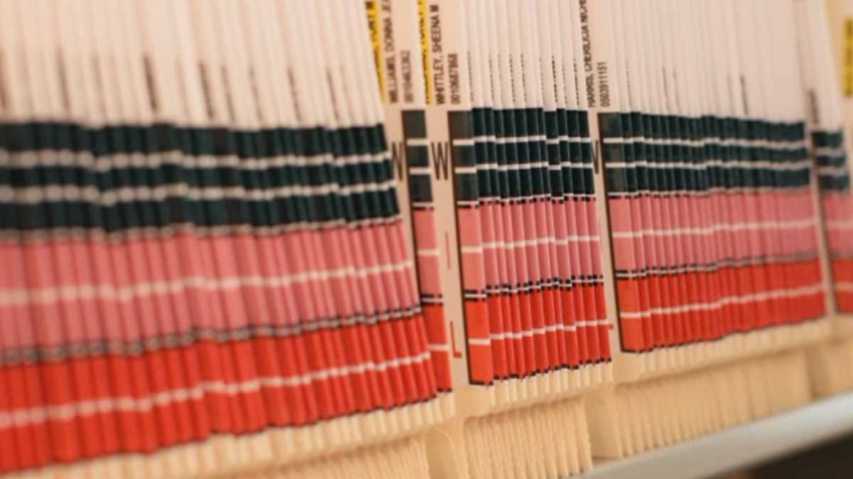 close-up of color-coded alphabetical filing tabs used to identify and organize files by name