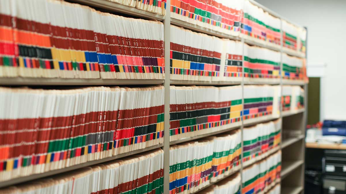labeled file folders stored on open shelving for quick access to police case records