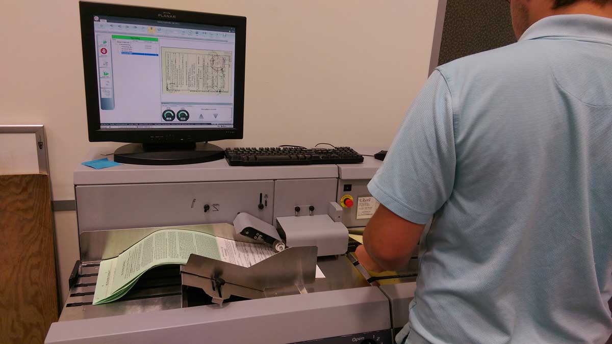 technician reviewing scanned legal documents on screen for accuracy