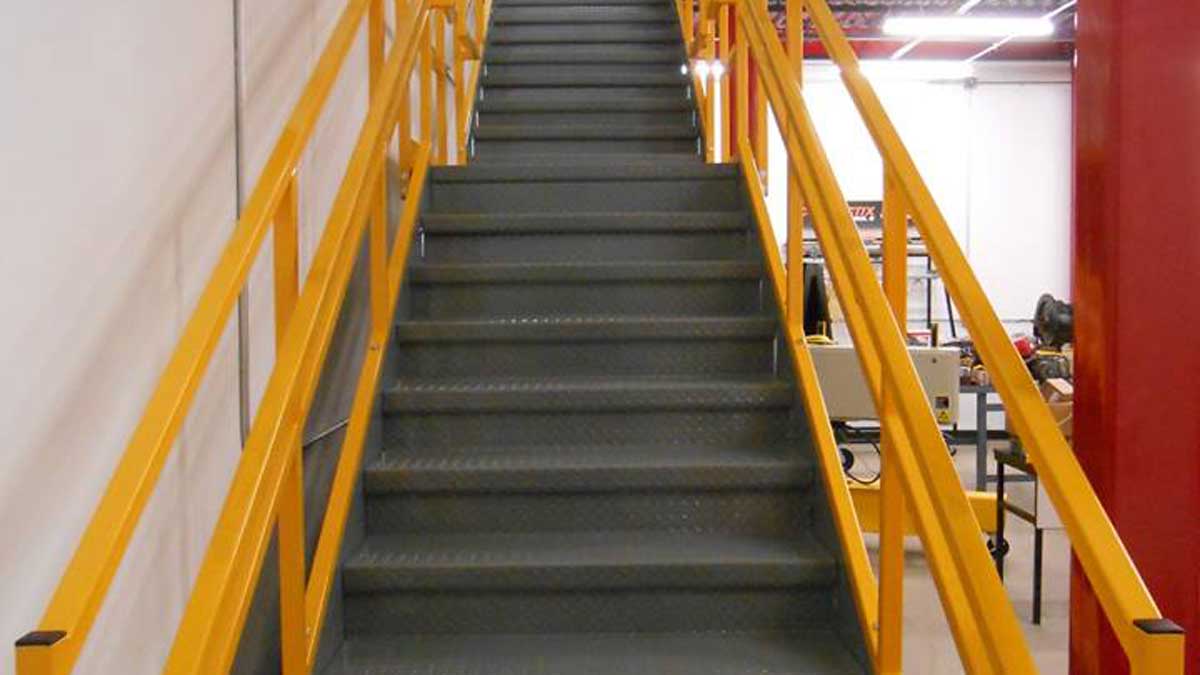 industrial mezzanine staircase with safety handrails for elevated platform access