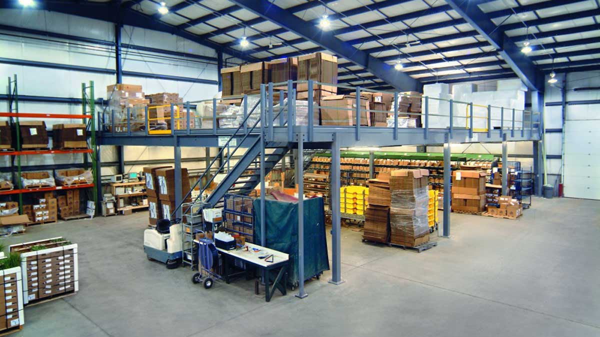 freestanding mezzanine installed above warehouse operations to maximize available overhead storage space