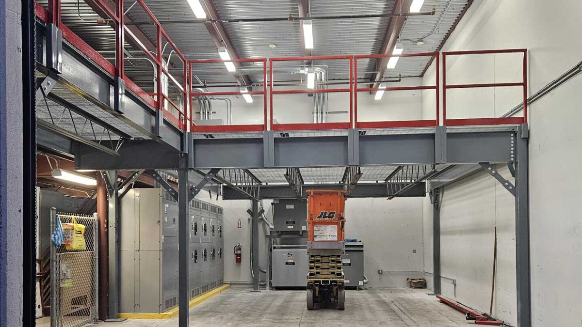 Steel mezzanine above facility equipment in a maintenance area
