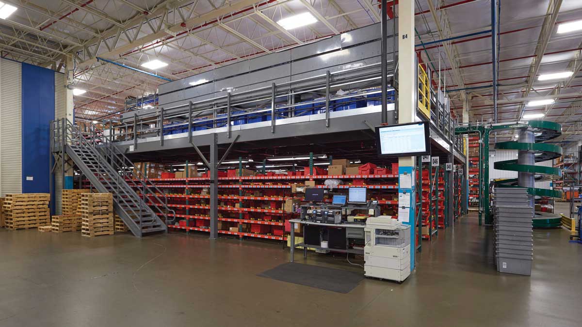 industrial platform with stair access, integrated conveyor, and high-capacity shelving for streamlined order picking