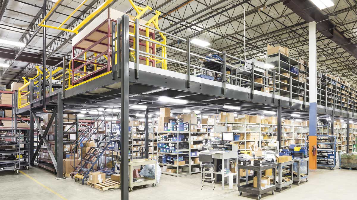 steel mezzanine structure above shelving for high-density storage in distribution and assembly facilities