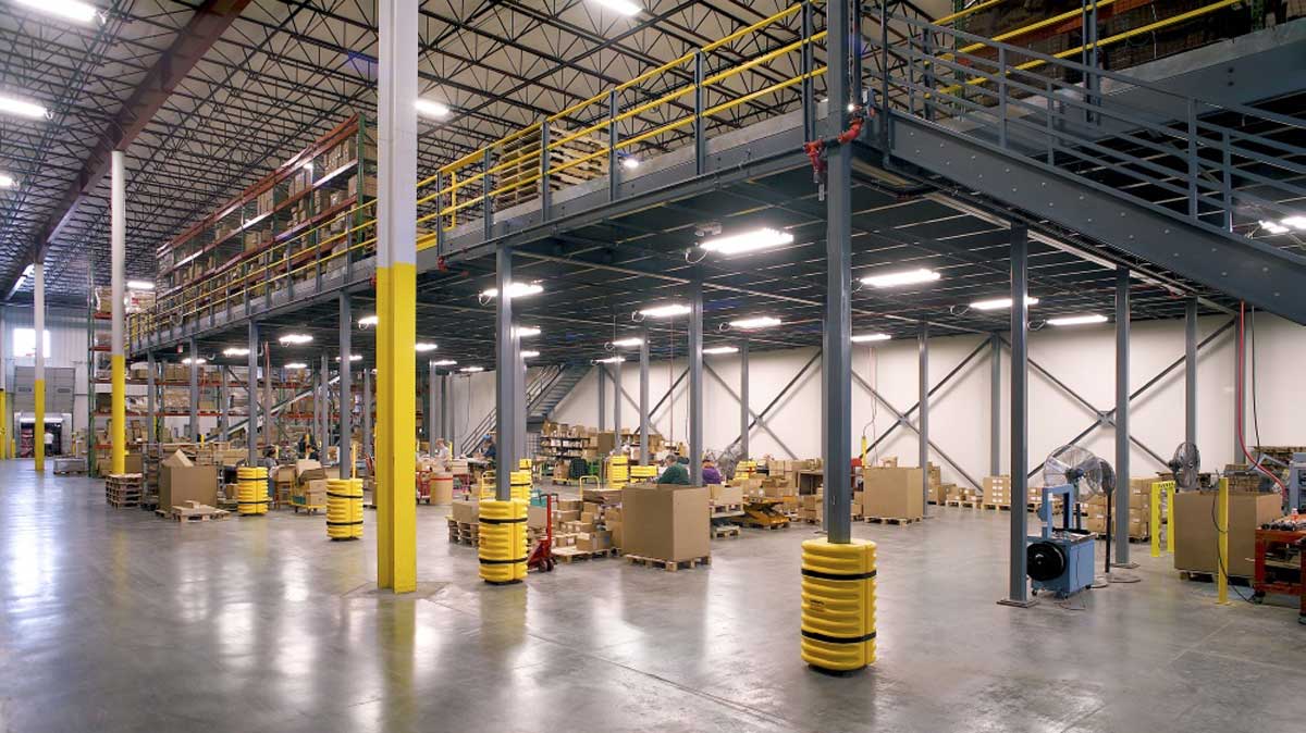 long-span mezzanine over workstations and storage racks to expand warehouse capacity and streamline workflow