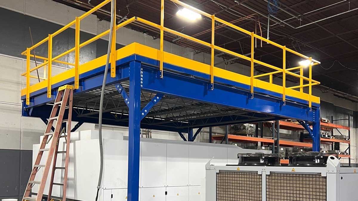 elevated steel mezzanine structure with safety rails installed above machinery for added storage and floor space optimization