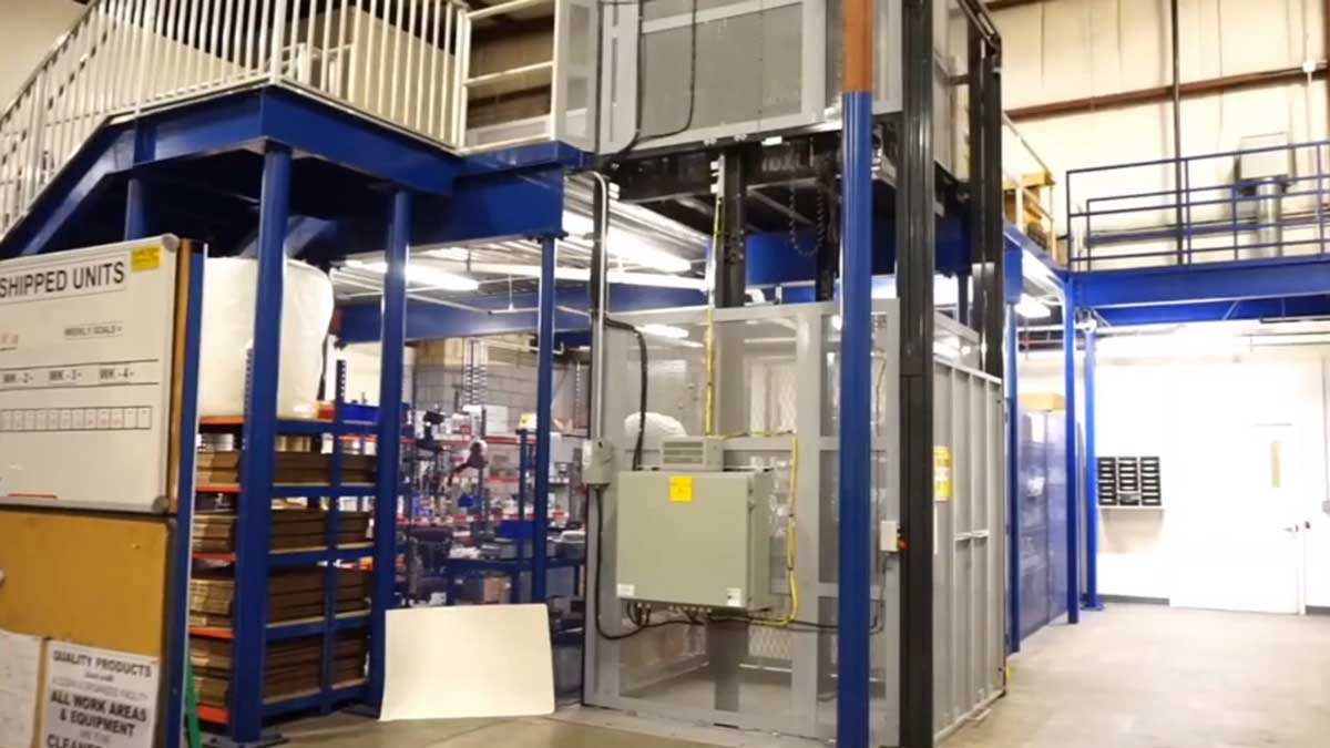 industrial mezzanine platform connected to powered lift for transporting bulk materials between levels