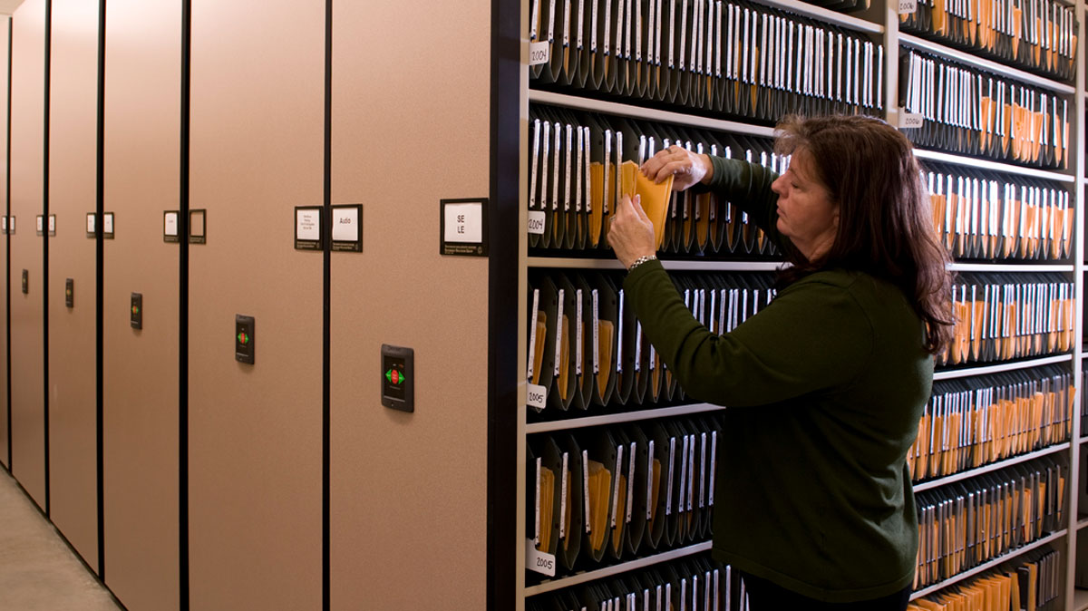high density shelving for organized archival records storage using labeled file folders