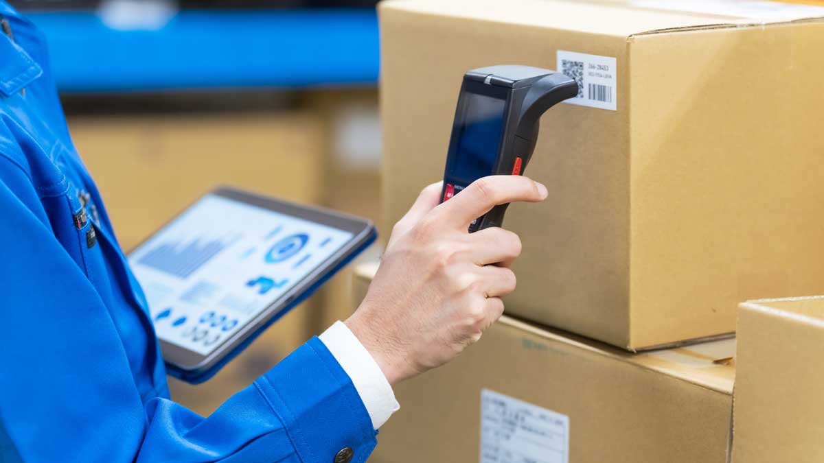 barcode scanner used on boxes with tablet-based inventory software for tracking and logistics
