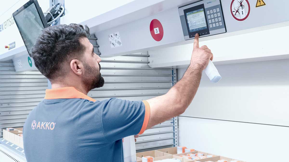 technician selecting items using pick-to-light system on vertical carousel storage