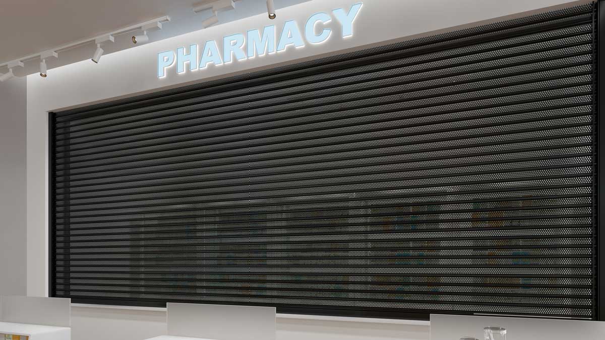 interior pharmacy area secured with perforated security door providing barrier while allowing visibility