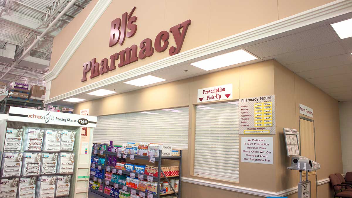 closed security shutters over pharmacy prescription pick-up counter for theft prevention and controlled access