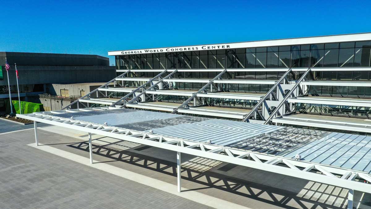 angled view of steel canopy structure at conference center entrance showing support framing