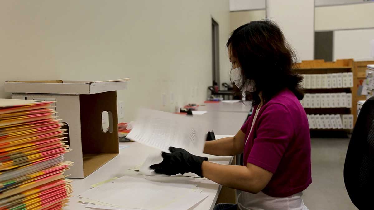 technician preparing color-coded files for digital scanning and archival processing