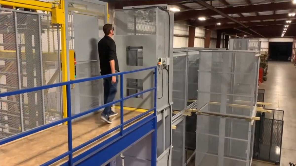 elevated walkway with secured material lift for efficient transport of goods to mezzanine platforms