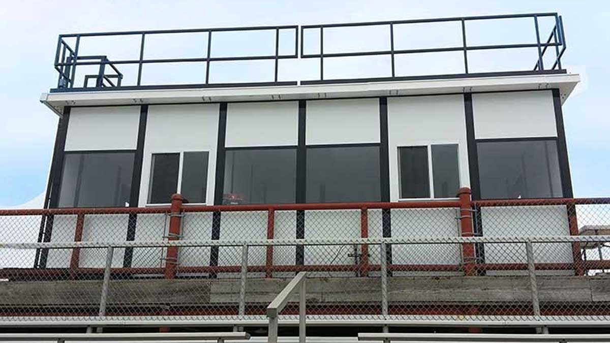 modular press box with rooftop deck and guardrail for camera operators