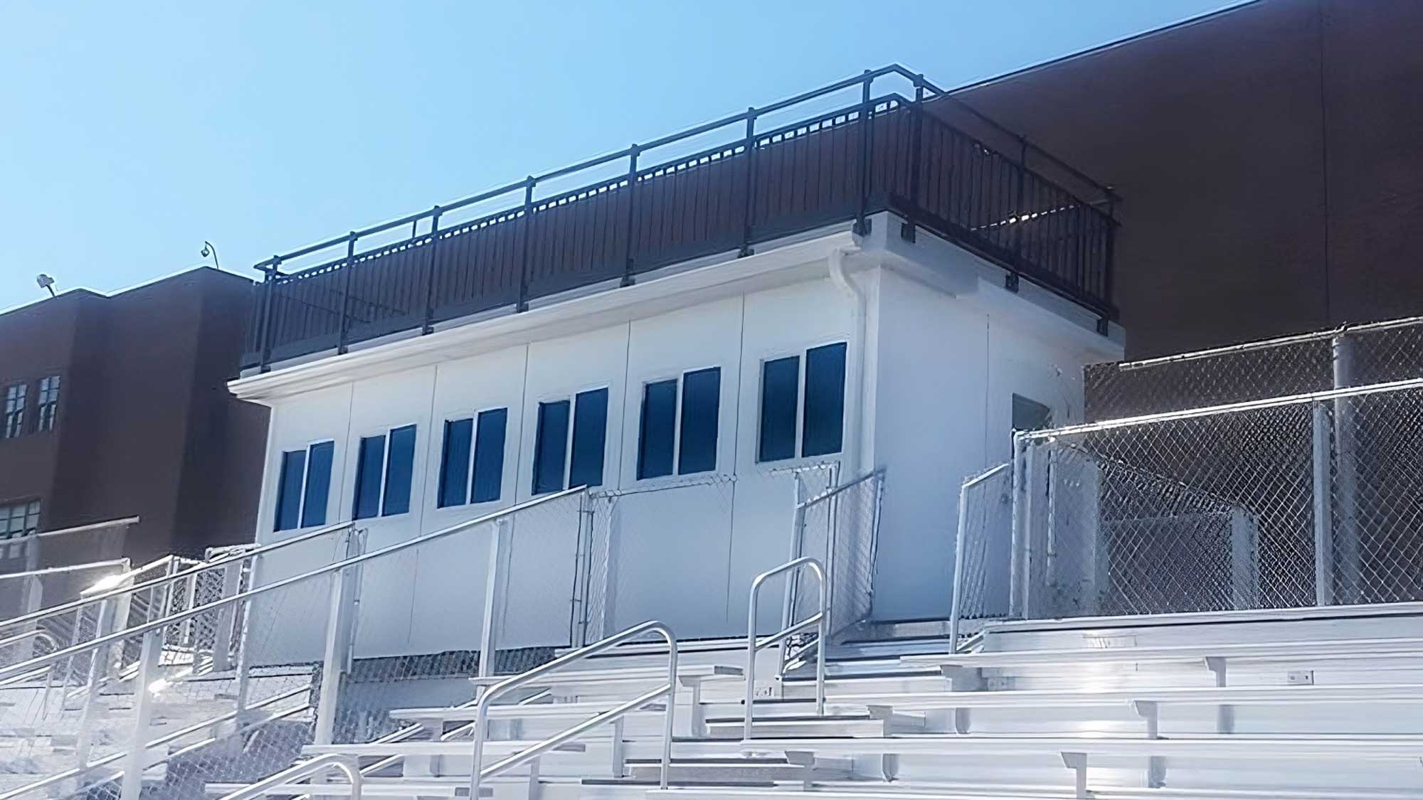 press box featuring elevated camera deck and safety railing for event filming