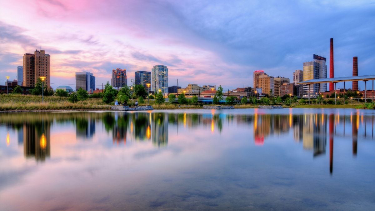 Downtown skyline lakefront view Alabama with city buildings reflected on water