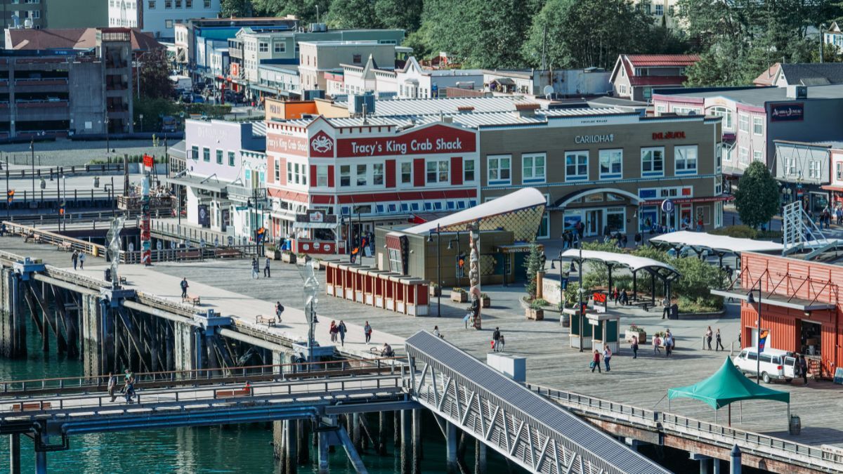 Juneau waterfront boardwalk with shops, pier access, and pedestrians