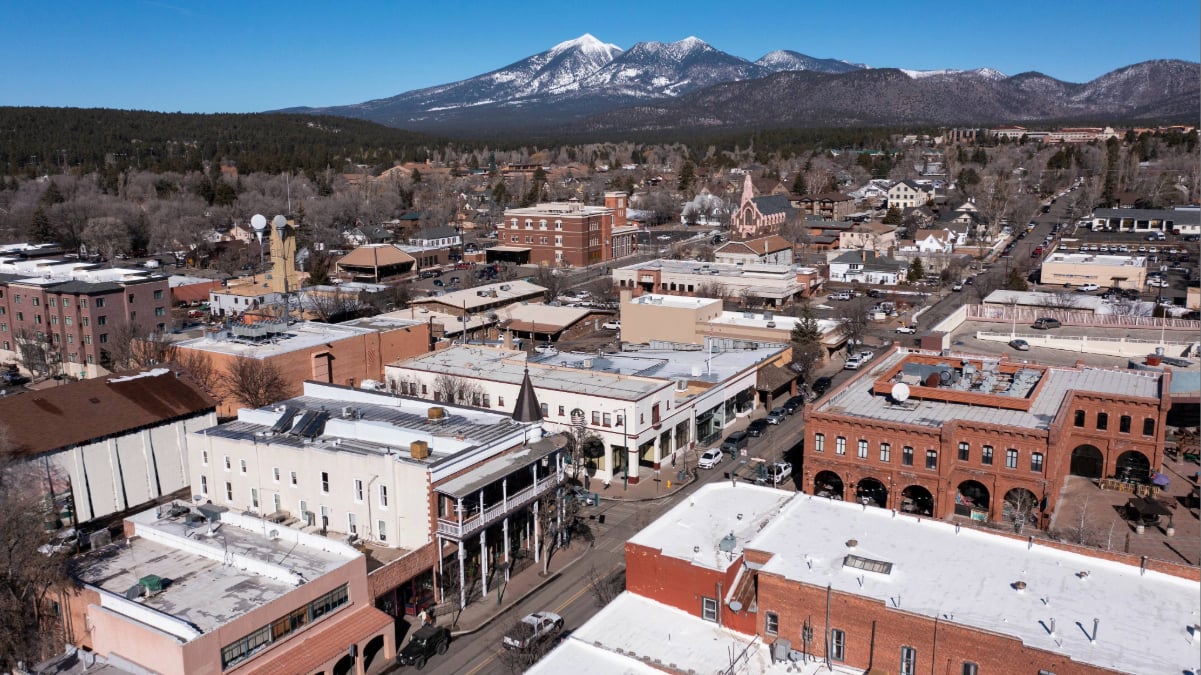 Downtown Flagstaff with mountain backdrop and snow covered peaks