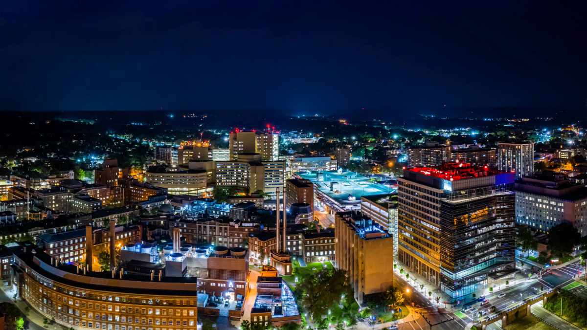 Downtown skyline aerial Bridgeport at night with illuminated office buildings