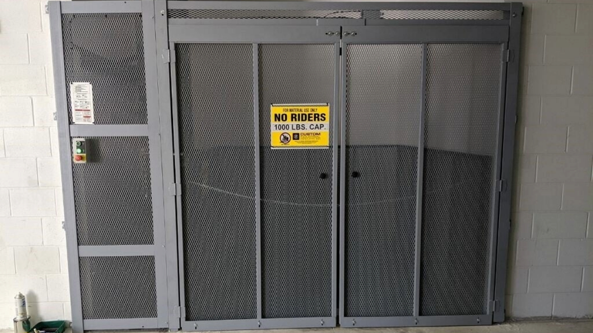 Material lift enclosure gate for secure vertical transport and restricted access