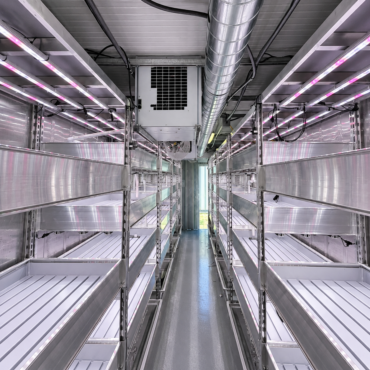 Factory-built 40-foot turnkey grow container with a finished insulated interior, racked cannabis plants, and built-in climate and lighting